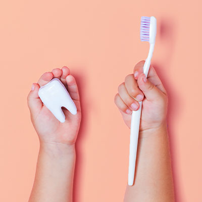 Tooth and brush in child hand