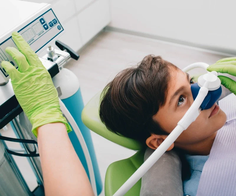 "Child receiving nitrous oxide dental sedation in a pediatric dental clinic for a calm and safe procedure"