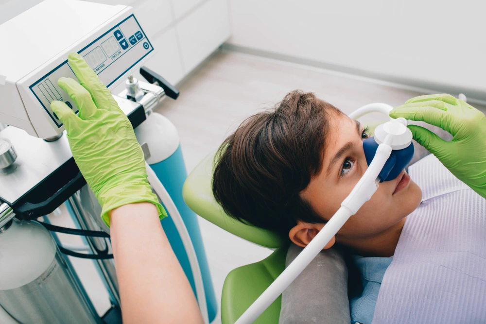 "Child receiving nitrous oxide dental sedation in a pediatric dental clinic for a calm and safe procedure"